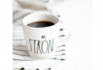Photo of a coffee cup with "Be strong" written on it