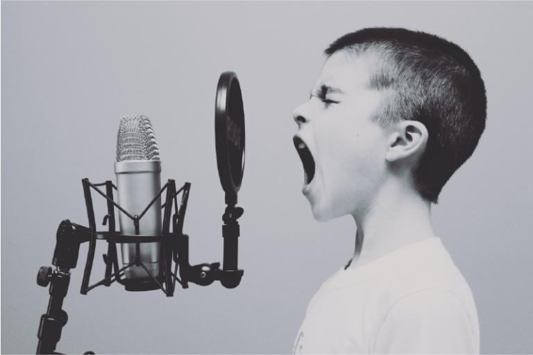 Child yelling into an old fashioned microphone